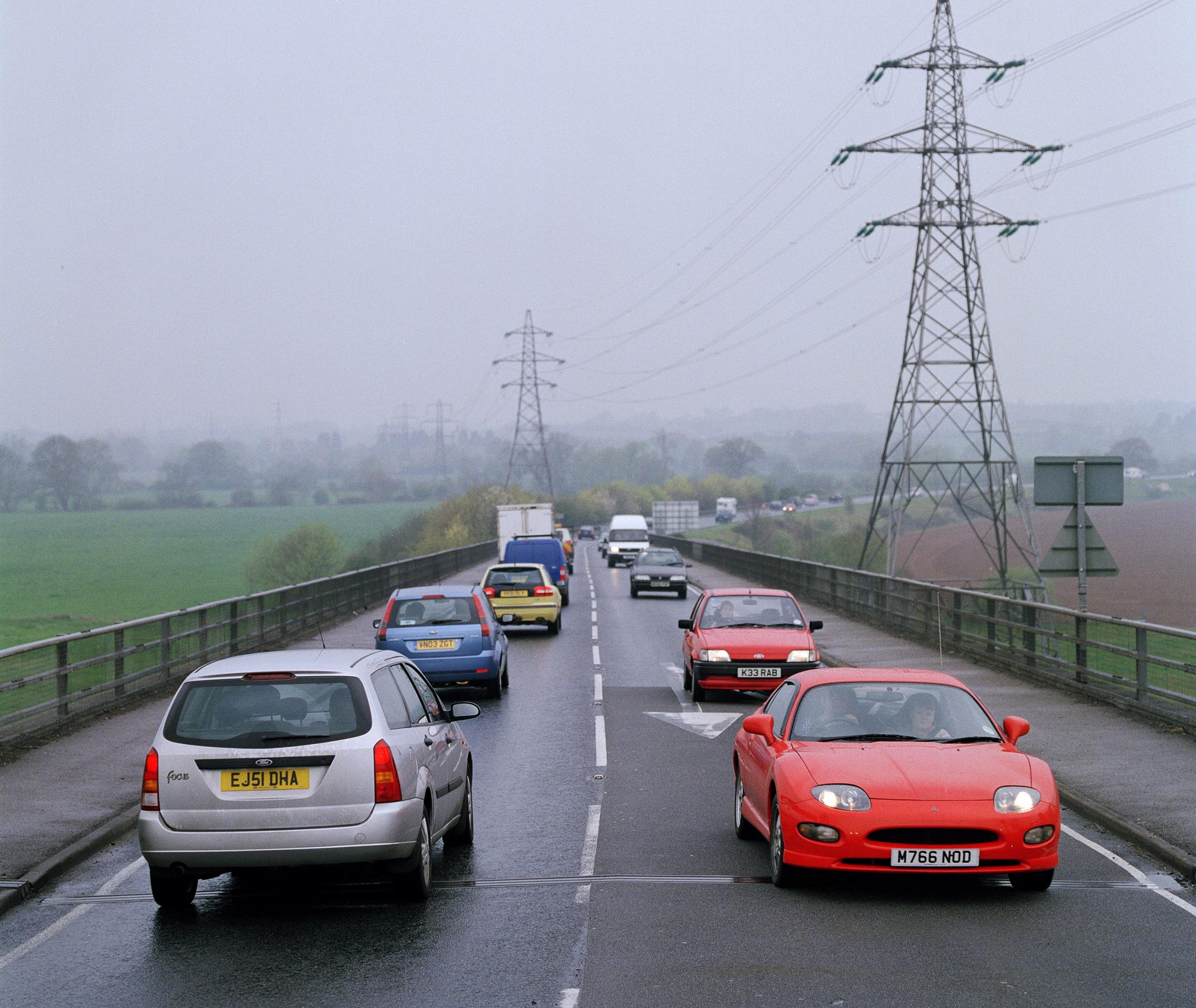 A single carriageway road busy with traffic